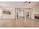 Bright and airy living space featuring tile floors, a fireplace, and an open layout to the kitchen at 16704 W Oracle Rim Dr, Surprise, AZ 85387