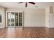 Empty living area with fan, sliding door, and a window at 16704 W Oracle Rim Dr, Surprise, AZ 85387