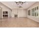 Expansive living room with tile flooring, a fireplace, and an abundance of natural light from large windows at 16704 W Oracle Rim Dr, Surprise, AZ 85387