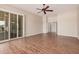 Large living area with fan, sliding doors and a door to another room at 16704 W Oracle Rim Dr, Surprise, AZ 85387
