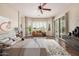 Staged main bedroom with walk-in closet, ceiling fan, and a bay window at 16704 W Oracle Rim Dr, Surprise, AZ 85387