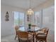 Cozy dining area with glass-top table, wicker chairs, and views of the community at 16715 E El Lago Blvd # 212, Fountain Hills, AZ 85268