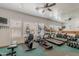 Bright home gym with multiple machines, weights, mirrored wall, and TV for a complete workout experience at 16715 E El Lago Blvd # 212, Fountain Hills, AZ 85268