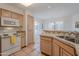 Bright kitchen with white appliances and tile countertops is adjacent to an eat-in kitchen and dining area at 16715 E El Lago Blvd # 212, Fountain Hills, AZ 85268