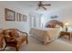 Bright main bedroom with ceiling fan, wicker furniture, and access to the screened in outdoor living area at 16715 E El Lago Blvd # 212, Fountain Hills, AZ 85268