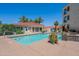Community pool featuring relaxing lounge seating and beautiful desert landscaping at 16715 E El Lago Blvd # 212, Fountain Hills, AZ 85268