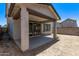 Covered back patio featuring a concrete floor and sliding glass doors to the home's interior at 1914 N Marketside Ave, Buckeye, AZ 85396