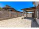 Backyard featuring a covered patio, xeriscaping and a cinder block wall around the perimeter at 1914 N Marketside Ave, Buckeye, AZ 85396