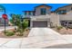 Front exterior of the home featuring a two-car garage, neutral-colored siding, and landscaped yard at 1914 N Marketside Ave, Buckeye, AZ 85396