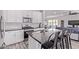 Bright kitchen with white cabinets, stainless steel appliances, dark countertops, and island with barstool seating at 1914 N Marketside Ave, Buckeye, AZ 85396
