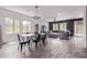Open-concept living area featuring wood floors, natural light and contemporary furnishings at 1914 N Marketside Ave, Buckeye, AZ 85396