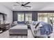 Living room features gray sectional seating, TV and plank flooring at 1914 N Marketside Ave, Buckeye, AZ 85396