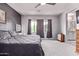 Comfortable main bedroom with a ceiling fan, neutral color scheme, carpeted floor, and natural light from multiple windows at 1914 N Marketside Ave, Buckeye, AZ 85396