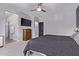 Spacious main bedroom with neutral walls, carpeted floor, ceiling fan, and natural light from a large window at 1914 N Marketside Ave, Buckeye, AZ 85396