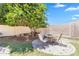 Backyard includes mature tree and brick-paved patio with table and chairs at 20507 W Daniel Pl, Buckeye, AZ 85396