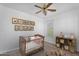 Cozy Bedroom showcases a crib, ceiling fan, and charming wall art at 20507 W Daniel Pl, Buckeye, AZ 85396