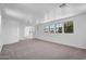 Large bonus room featuring neutral walls, carpeting, and abundant natural light from multiple windows at 20507 W Daniel Pl, Buckeye, AZ 85396