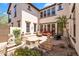 Inviting courtyard offers a serene outdoor retreat with comfortable seating, statues, and lush plants at 20507 W Daniel Pl, Buckeye, AZ 85396