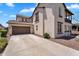 Two-story home exterior features a two-car garage, balcony, and spacious driveway at 20507 W Daniel Pl, Buckeye, AZ 85396