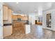 Open-concept kitchen boasting wooden cabinets, granite countertops, stainless steel appliances, and tile flooring at 20507 W Daniel Pl, Buckeye, AZ 85396