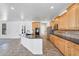 Spacious kitchen featuring an island with black countertops, wood cabinets, and stainless steel appliances at 20507 W Daniel Pl, Buckeye, AZ 85396