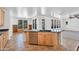 Kitchen island with stainless steel dishwasher, black countertop, and wood cabinets at 20507 W Daniel Pl, Buckeye, AZ 85396