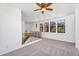 Open loft space with staircase, large windows, and a ceiling fan at 20507 W Daniel Pl, Buckeye, AZ 85396