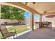 Spacious covered patio features an outdoor kitchen, lush lawn, and comfortable seating area at 20507 W Daniel Pl, Buckeye, AZ 85396