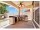 Covered patio features a stainless-steel built-in outdoor kitchen with bar seating at 20507 W Daniel Pl, Buckeye, AZ 85396