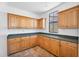 Well-lit pantry features ample cabinet space, countertops, and a window at 20507 W Daniel Pl, Buckeye, AZ 85396