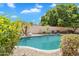Backyard pool is surrounded by mature landscaping and rock borders, creating a tranquil oasis at 20507 W Daniel Pl, Buckeye, AZ 85396