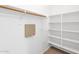 Functional closet featuring wooden rod, white shelving, and good storage at 20507 W Daniel Pl, Buckeye, AZ 85396