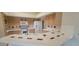 Well-lit kitchen showcases tiled countertops, ample cabinetry, and updated appliances at 20641 N 110Th Ave, Peoria, AZ 85373