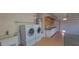 Functional laundry area featuring modern washer and dryer set, sink, and ample storage solutions at 20641 N 110Th Ave, Peoria, AZ 85373
