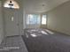 Bright living room with carpet, large windows, and a decorative front door at 20641 N 110Th Ave, Peoria, AZ 85373