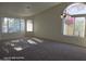 Spacious living room with carpet, ample natural light, and neutral walls at 20641 N 110Th Ave, Peoria, AZ 85373