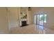 Bright living room with tiled floors featuring fireplace and sliding glass door access to outdoors at 20641 N 110Th Ave, Peoria, AZ 85373