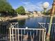 Scenic pond view with lush landscaping, and neighborhood homes across the calm waters at 20641 N 110Th Ave, Peoria, AZ 85373