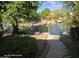 Beautiful pond view of the community featuring mature trees and lush landscaping at 20641 N 110Th Ave, Peoria, AZ 85373