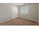 The bedroom features a double closet with white doors, neutral-toned walls, and carpeted flooring for warmth at 21039 E Avenida Del Valle --, Queen Creek, AZ 85142