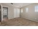 Comfortable bedroom showcasing neutral walls, carpet, and a closet for ample storage space at 21039 E Avenida Del Valle --, Queen Creek, AZ 85142