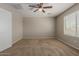 Inviting bedroom with a ceiling fan and a window allowing natural light, with cozy carpet at 21039 E Avenida Del Valle --, Queen Creek, AZ 85142