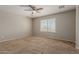 Bright bedroom with a ceiling fan and a window offering exterior views, plus neutral walls at 21039 E Avenida Del Valle --, Queen Creek, AZ 85142