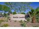Ocotillo Landing community sign with lush desert landscaping and vibrant green trees against a bright blue sky at 21039 E Avenida Del Valle --, Queen Creek, AZ 85142