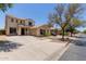 A tan two story home with a driveway and desert landscaping against a clear blue sky at 21039 E Avenida Del Valle --, Queen Creek, AZ 85142