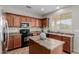 A kitchen showcasing wood cabinetry, stainless steel appliances, and a convenient island at 21039 E Avenida Del Valle --, Queen Creek, AZ 85142