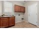 Functional laundry room with ample cabinet storage and a utility sink for convenience at 21039 E Avenida Del Valle --, Queen Creek, AZ 85142