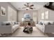 Cozy living room with neutral tones, comfortable sofas, and a stylish ceiling fan at 21039 E Avenida Del Valle --, Queen Creek, AZ 85142