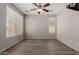Bright living space with modern ceiling fan and wood-look laminate flooring, filled with natural light at 21039 E Avenida Del Valle --, Queen Creek, AZ 85142