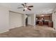 Spacious living room with an open floor plan, ceiling fan, and access to the kitchen at 21039 E Avenida Del Valle --, Queen Creek, AZ 85142
